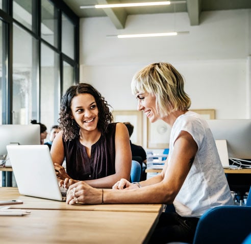 Two women looking at laptop