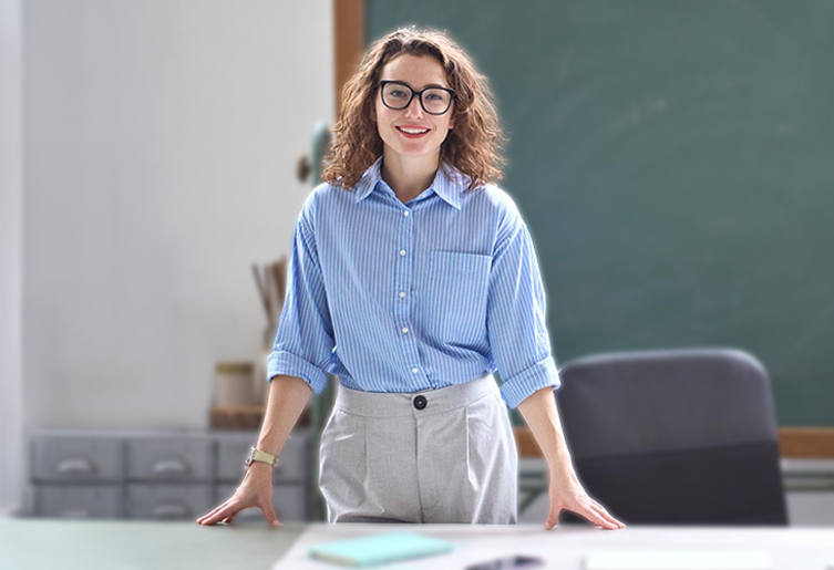 Teacher standing behind her desk