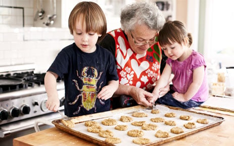 Woman making cookies with her children