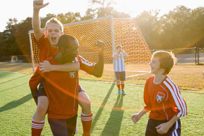 Kids cheering for a goal