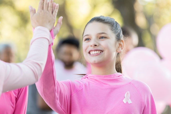 Girl wearing pink giving a high five