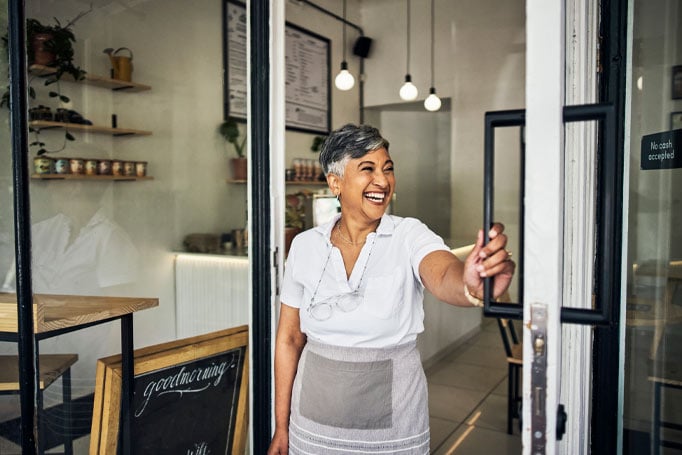 Woman holding the door and smiling