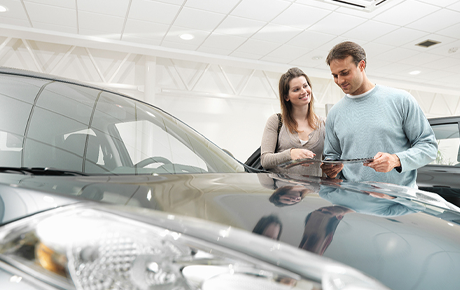 Couple looking at a car