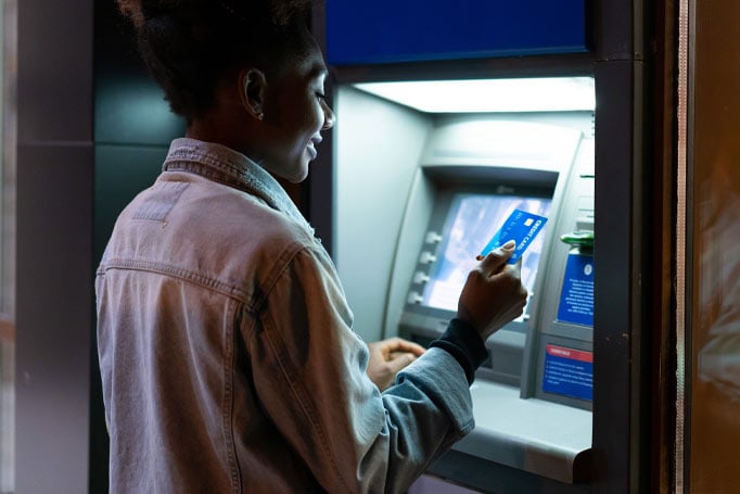 Woman using card at an ATM