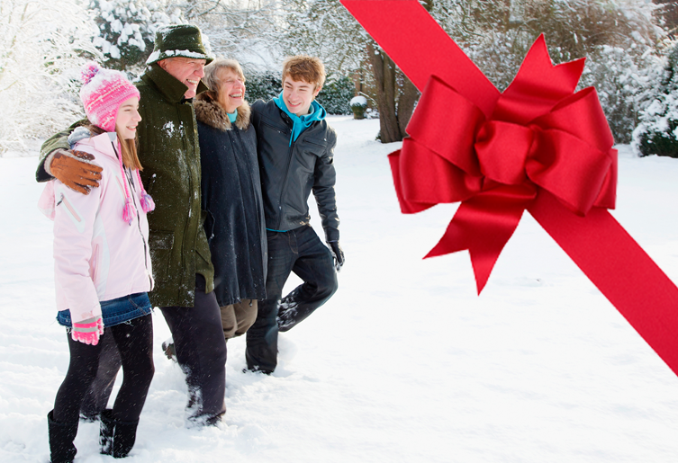 Family with arms around each other in the snow