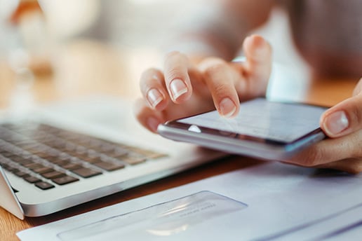 Keyboard with mail and hand using a phone