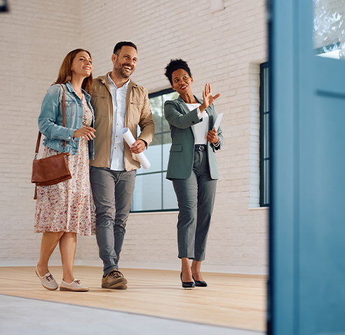 Couple looking at a home with realtor