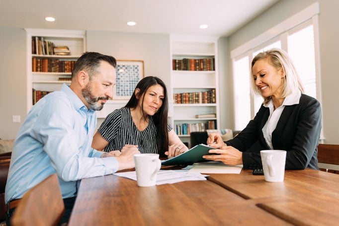 Agent helping couple with their documents