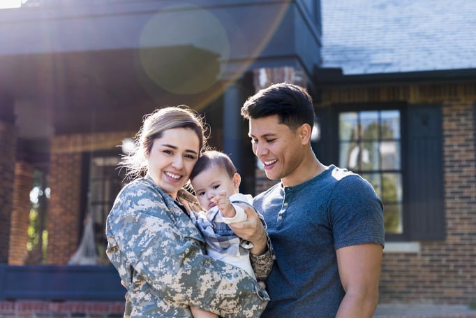 Military couple holding baby