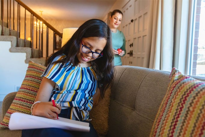 Young girl writing a letter